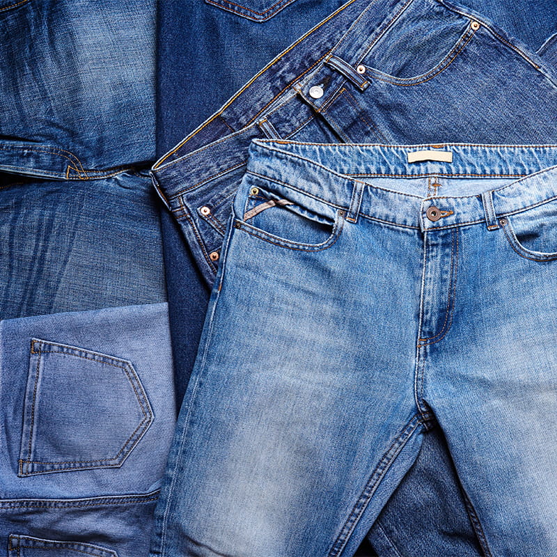 A,Heap,Of,Jeans.,Texture,Background.